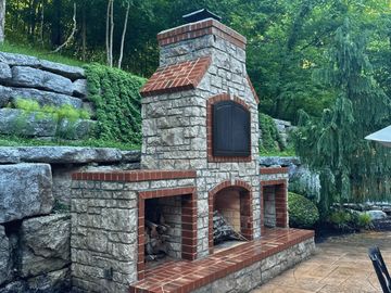 Custom brick and stone outdoor fireplace built by Moe's Masonry