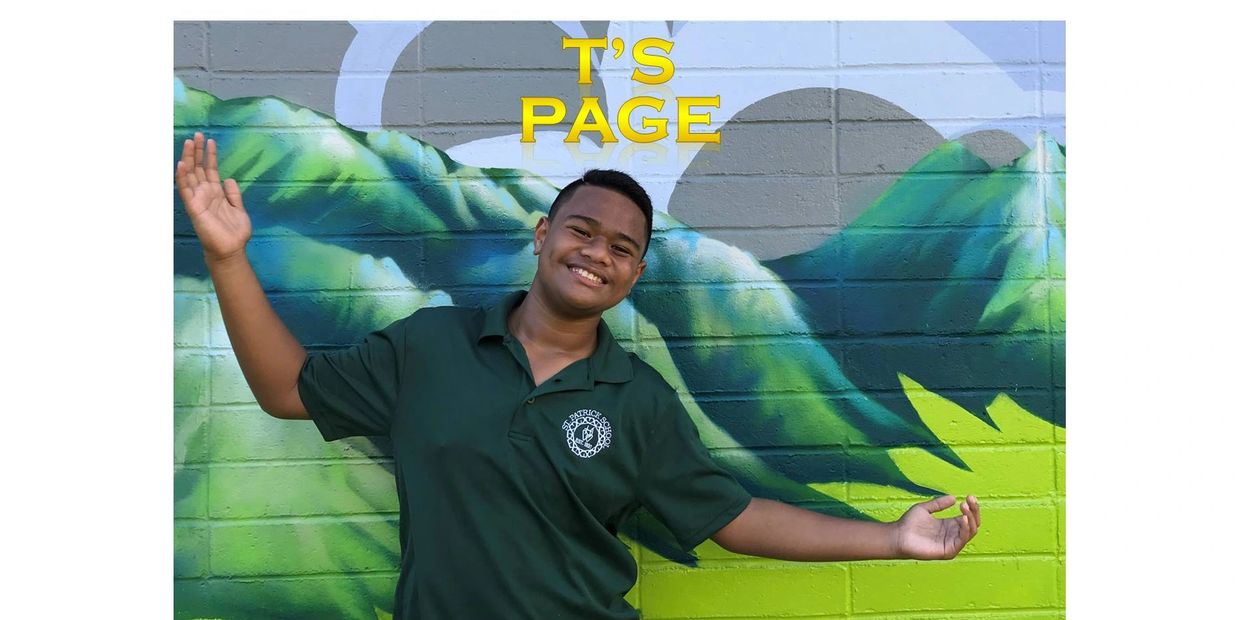 Smiling young man poses in front of colorful mural.