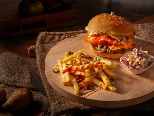 burger with french fries on a wooden board 