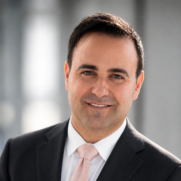 Professional man in suit smiling at the camera.