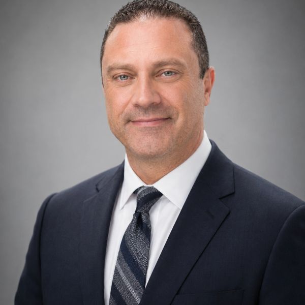 Professional man in a suit with a confident smile.