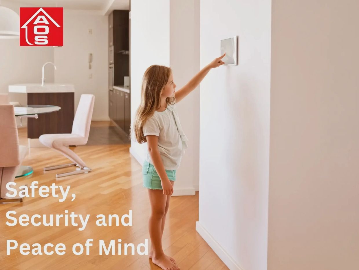 A young girl is in her kitchen arming her security system via the security keypad on the wall that w
