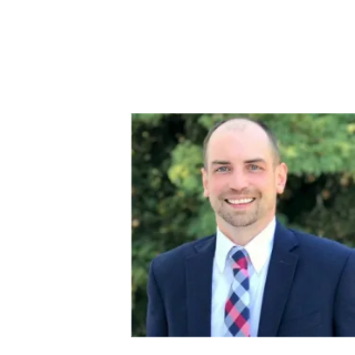 Smiling man in a suit with a colorful tie