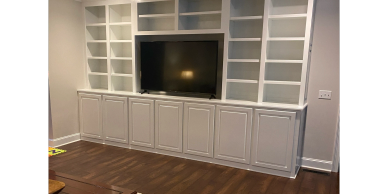 White built-in shelves with TV in the center.