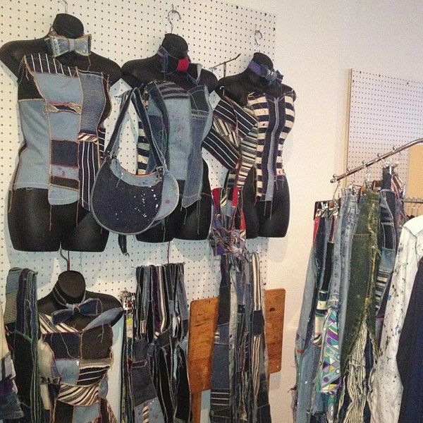 Reworked denim garments displayed on mannequins