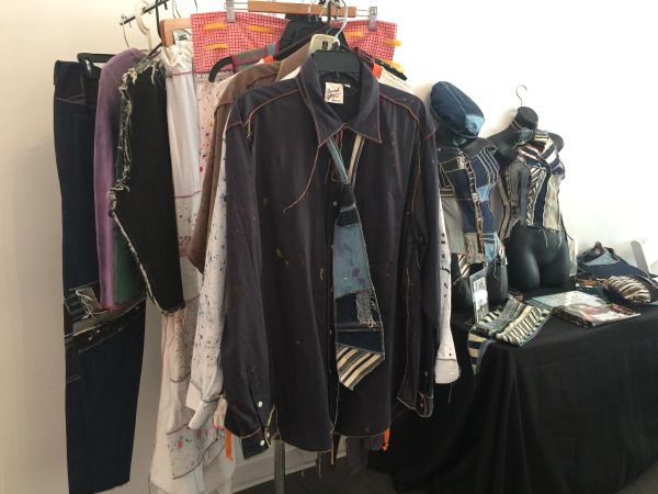 Reworked garments displayed on clothing rack