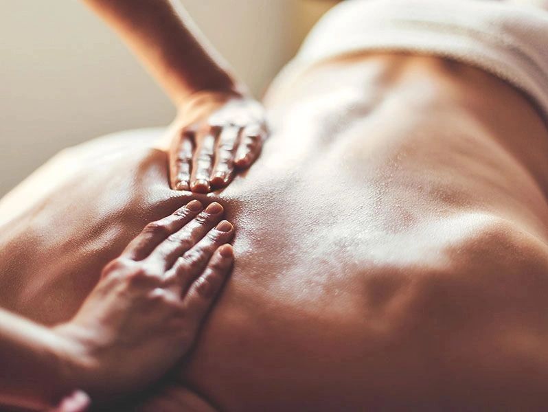 Close-up of a back massage with hands applying pressure.