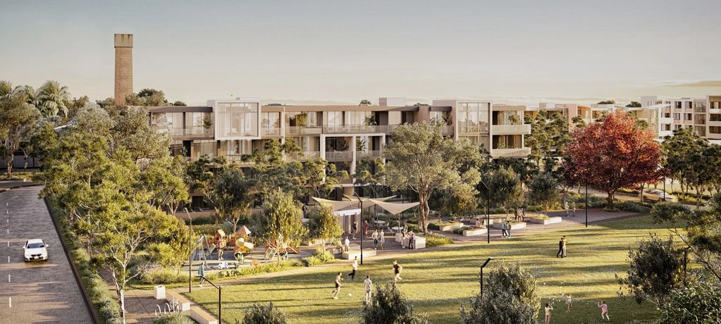 Modern apartments overlooking a lush park with people enjoying outdoor activities.
