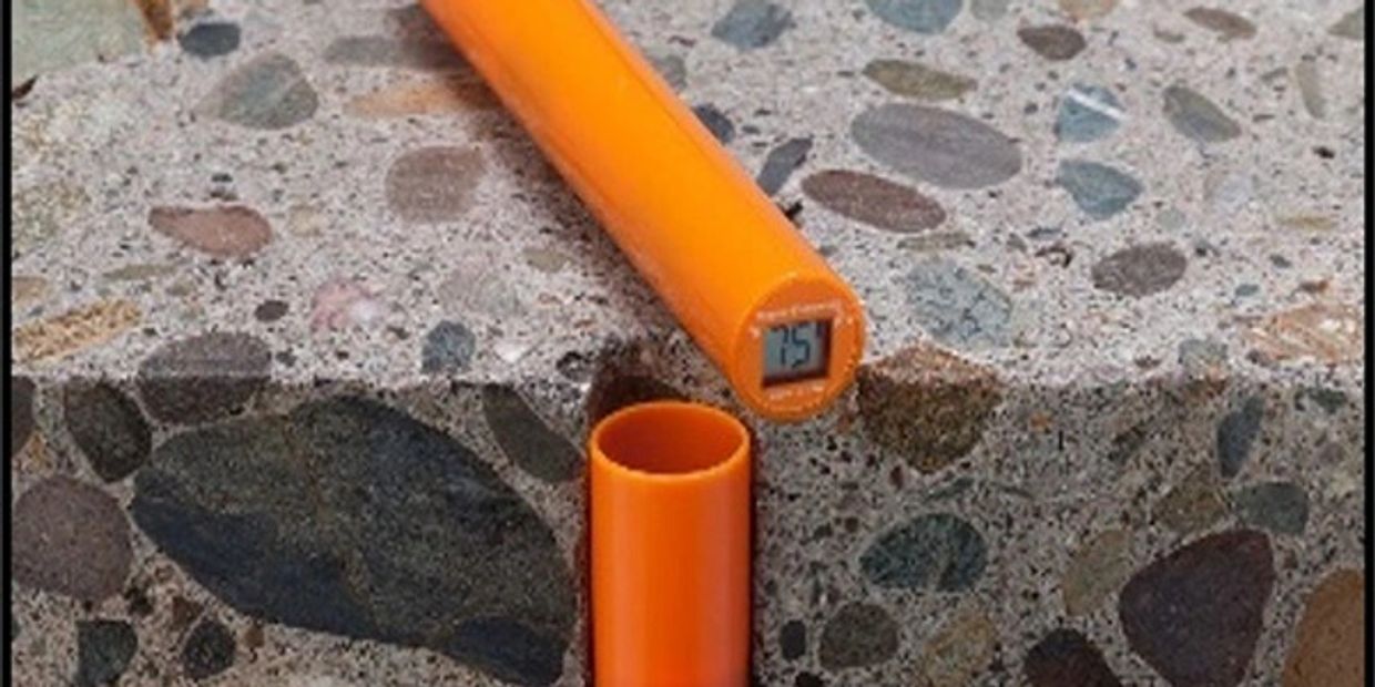 Orange digital level on terrazzo surface.