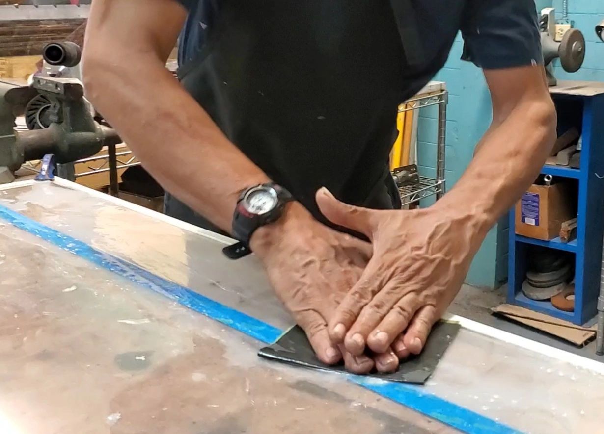 Jose Cuevas hand sands plexi glass with Klingspor PS11 Waterproof Material.