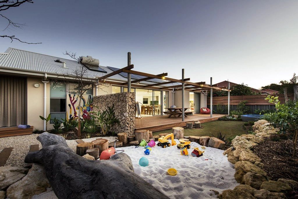 Cozy backyard with a sandbox and wooden deck.