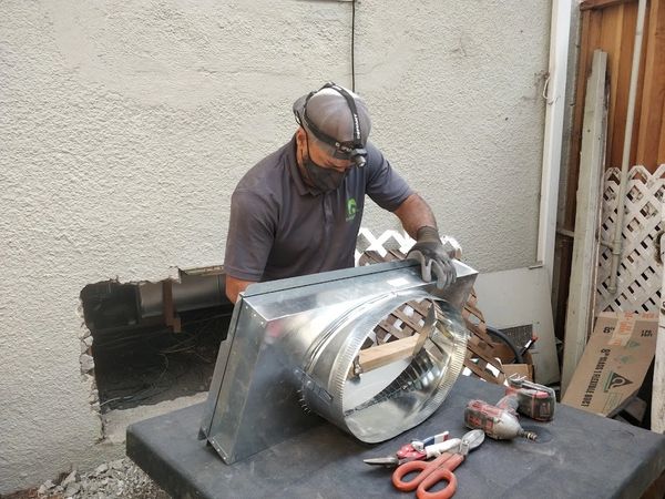 Team member Mikey building custom sheet metal transition