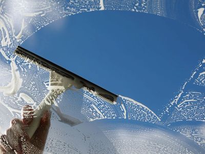 Squeegee cleaning a window during Louie's window cleaning service