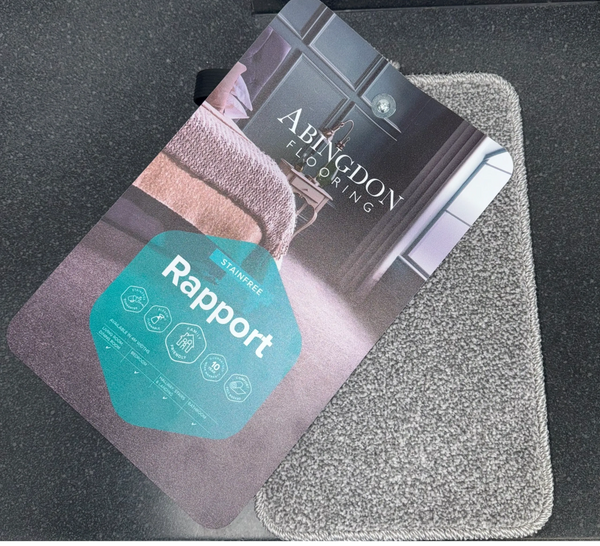 Carpet sample card for Abingdon Flooring's Rapport collection on a carpet swatch.