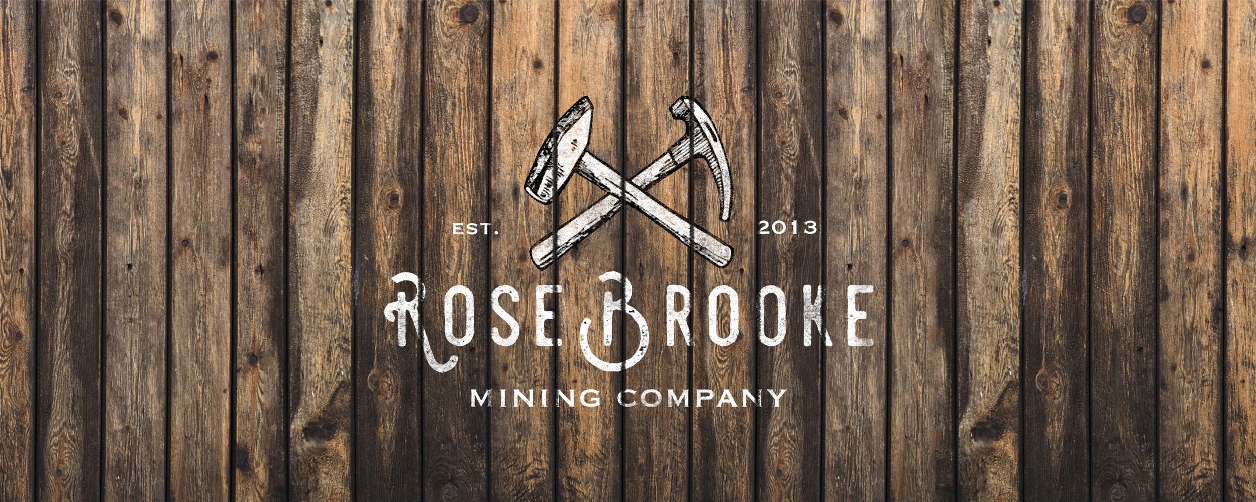 Casual outfit with green jacket, striped shirt, jeans, boots, yellow beanie, sunglasses, and camera.