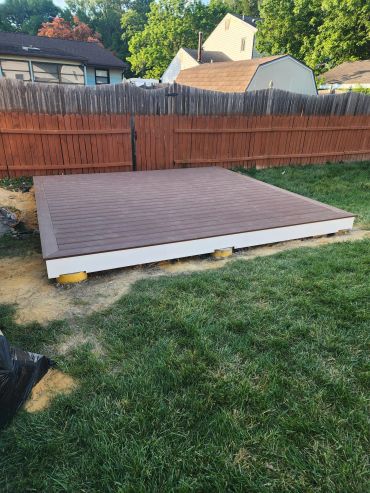 New wooden deck platform in a backyard.