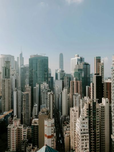 Dense cityscape with numerous high-rise buildings under a clear sky.