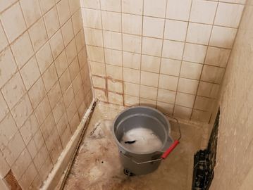 white tiled shower in middle of deep cleaning