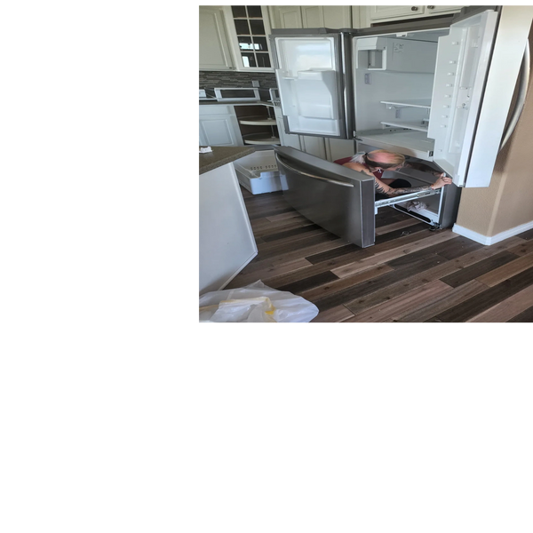 stainless steel refrigerator with all doors and drawers open in kitchen with wooden floors.