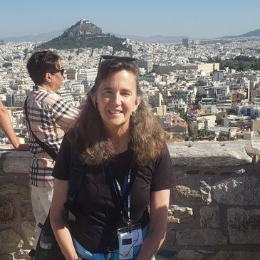 Woman’s face beaming with a smile, looking straight ahead