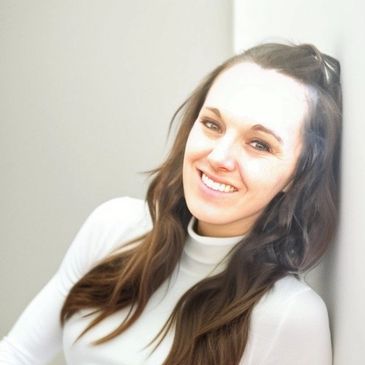 Woman with a gentle smile, eyes fixed ahead