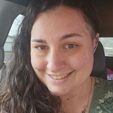 A cheerful woman’s face, smiling and looking straight ahead