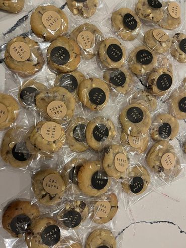 Individually wrapped cookies with thank you stickers in black and beige.