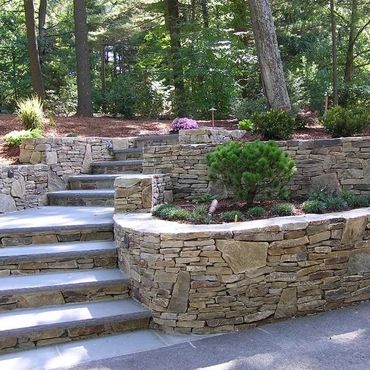 Contoured limestone steps and retaining garden walls
