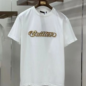 White t-shirt with shiny gold logo on the chest.
