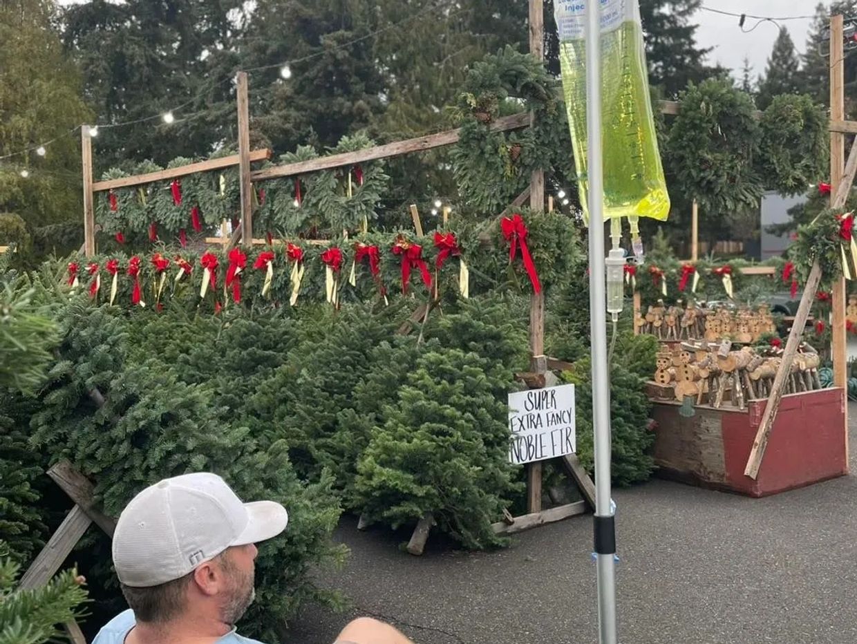 Gentleman with a Revive Drip IV at a Christmas Tree farm. Revive Drip meets you where you need them