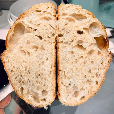 Freshly sliced rustic bread showing airy texture and crust.