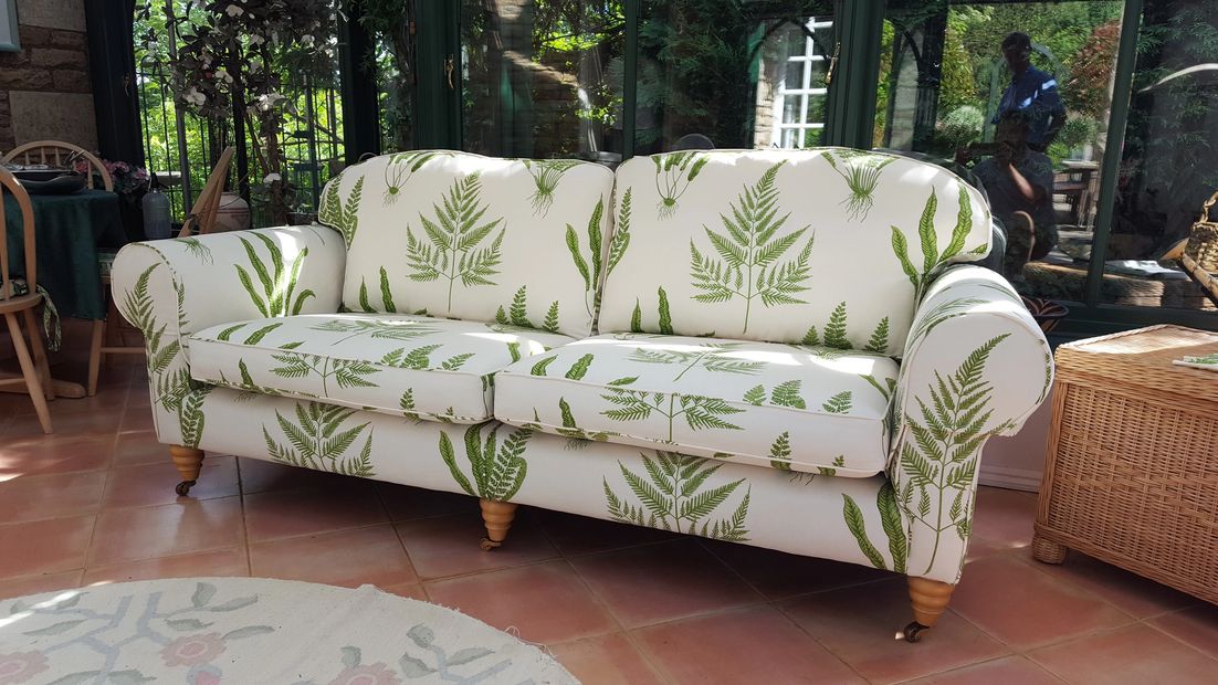 A recovered sofa in a conservatory 