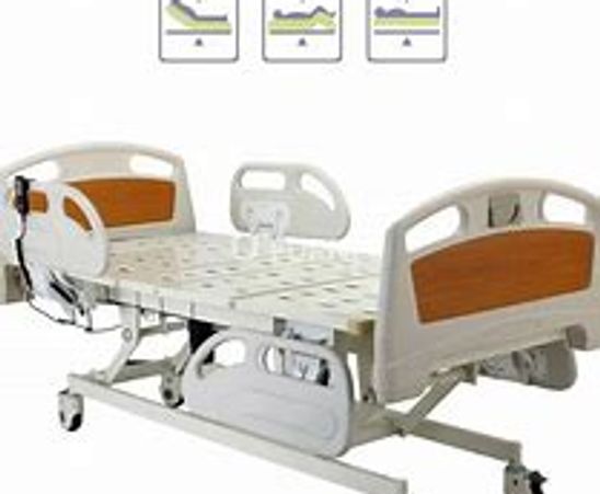 Adjustable hospital bed with wheels and side rails for patient care.