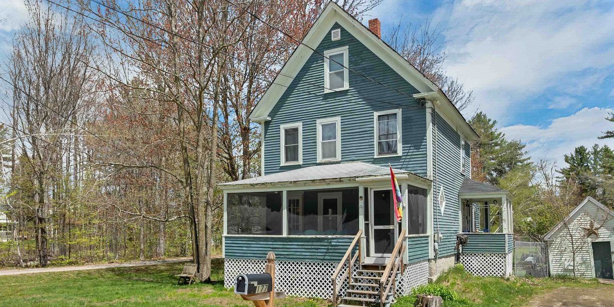 Blue two-story house with a screened porch and a mailbox in front.