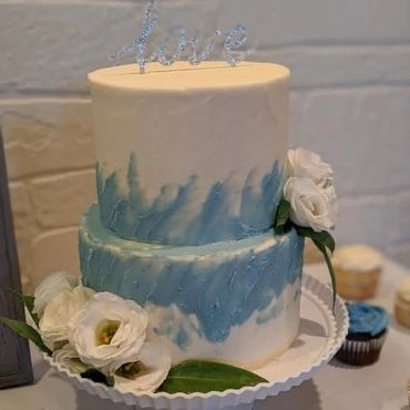 Two tiered cake with white and blue buttercream