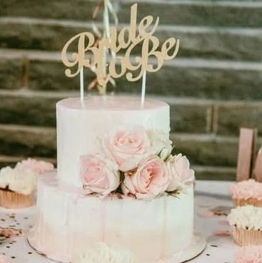 Two tiered white and pink drip cake