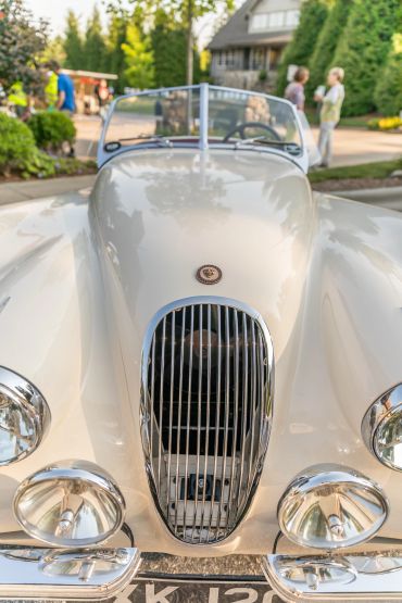 Close-up of a classic white Jaguar car front.