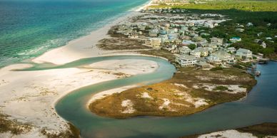 Aerial view of a coastal town with turquoise water and sandy beaches.