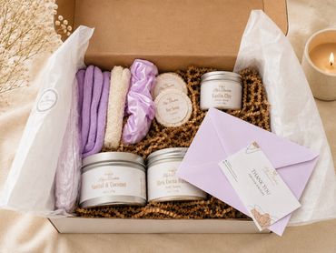 A cozy self-care gift box with skincare products and a thank you note.