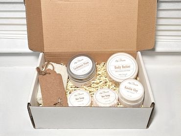 Gift box with natural skincare products and a decorative tag.