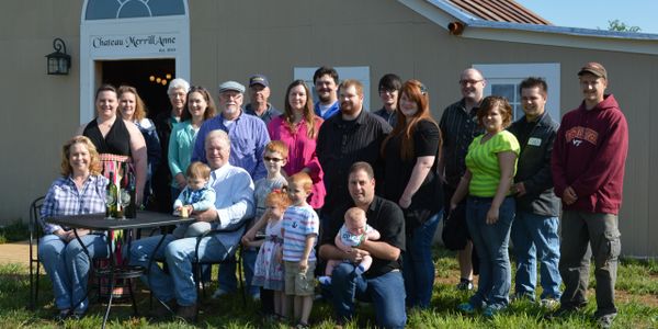 A group picture of friends and family of Chateau MerrillAnne posing in front of the tasting room.