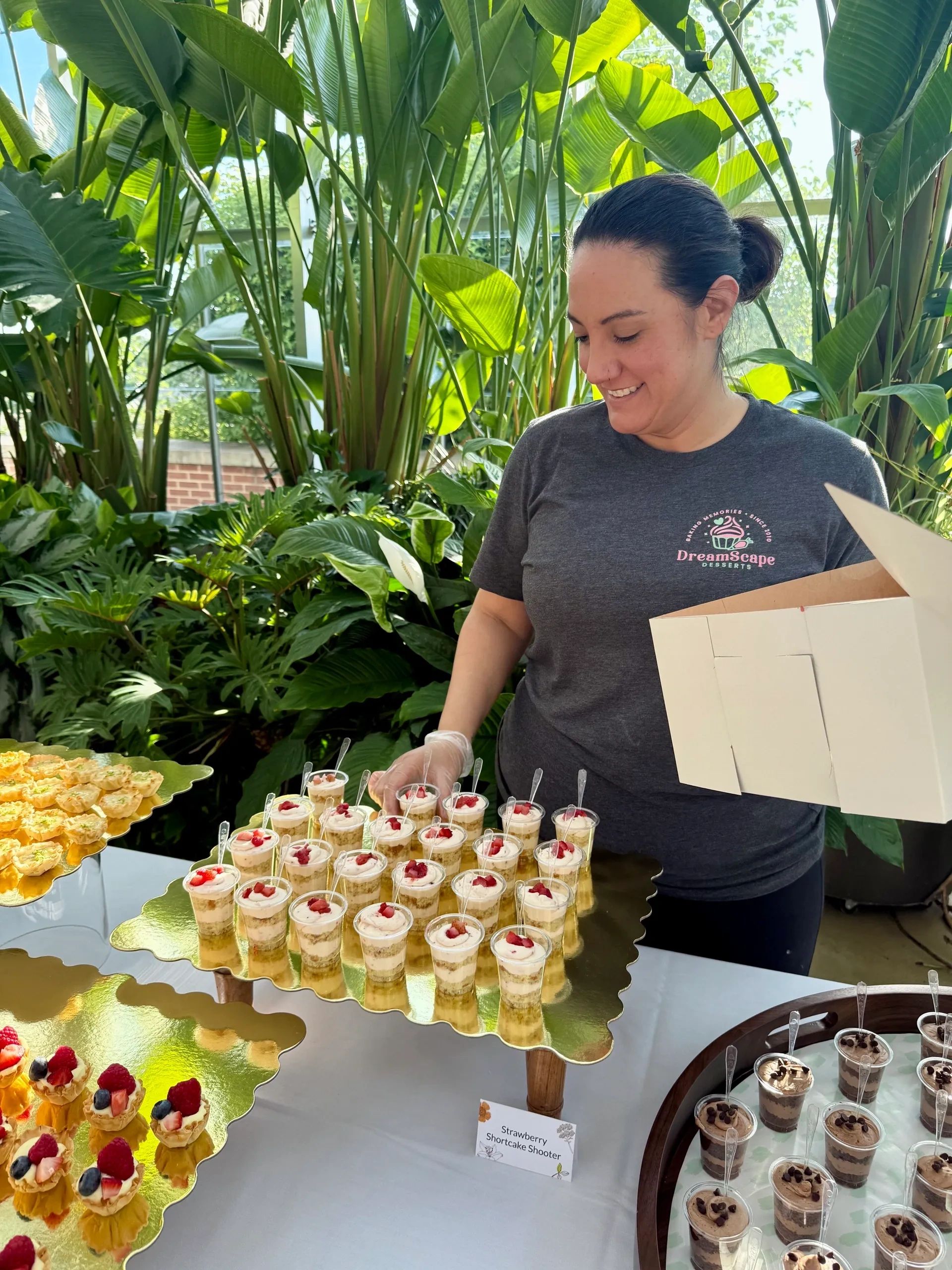 Karisa setting up a dessert bar at a wedding a the Downtown Market Grand Rapids