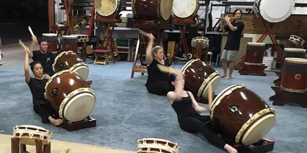 Cairns Taiko's Intermediate Class surrounded by some of the drums in our collection.