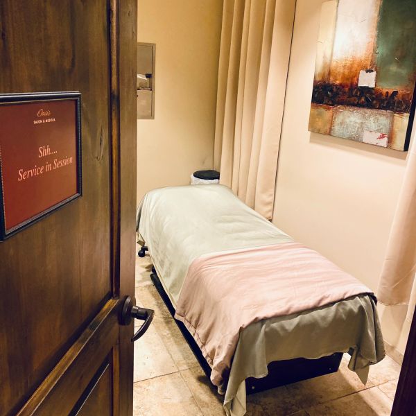 Massage room with a table and a 'Service in Session' sign.