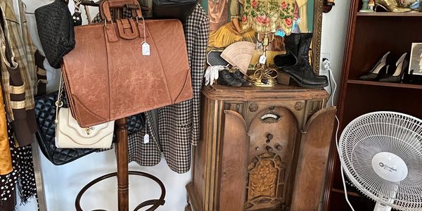 Vintage items including bags, shoes, and an old radio.