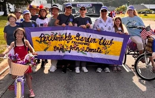 Group holding a Periwinkle Garden Club banner.