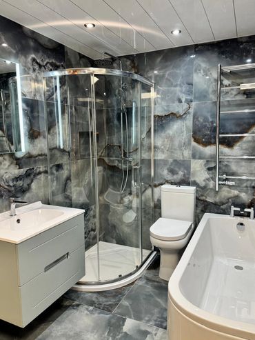 Blue and grey full size bathroom suite including a 'J' Bath, quadrant shower, close coupled toilet
