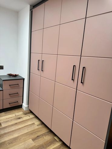 Picture of our Pink Bedroom display with black handles and carcass