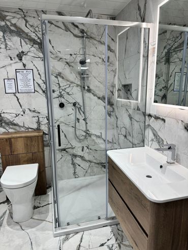 Marble an wood furniture bathroom display with illuminated mirror and back to wall wc