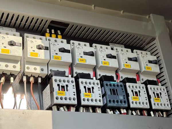 Siemens electrical contactors and circuit breakers in an industrial control panel.